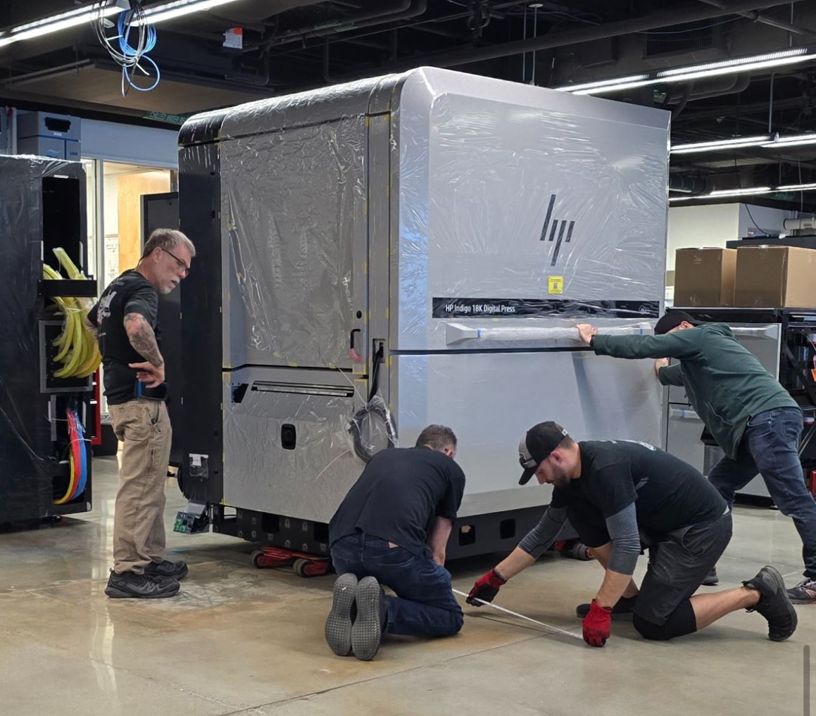 An Espie crew positioning an HP Indigo digital press